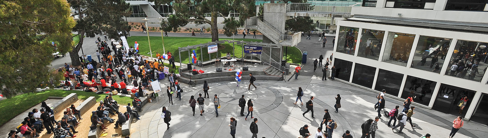 Aerial of a crowd walking through Malcolm X Plaza